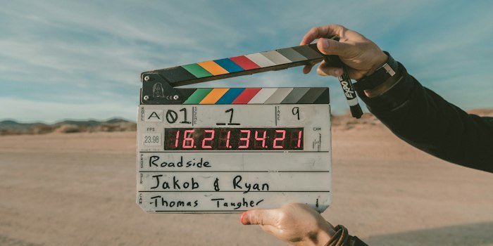 Behind the scenes photo of a major streaming platform original series production with directors cameras and actors on set